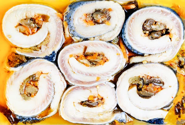 Korean rolls on slices of salt herring as background — Stock Photo, Image