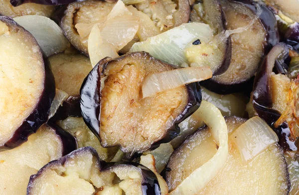 stock image Sliced and fried eggplants and onion as background