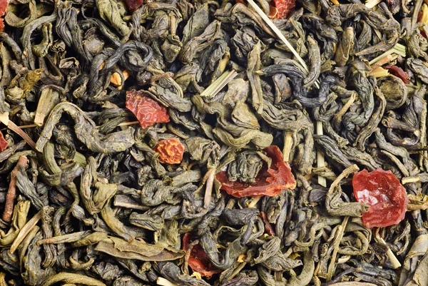 Groene thee met citroen schillen bloemblaadjes en kalk smaak als achtergrond — Stockfoto