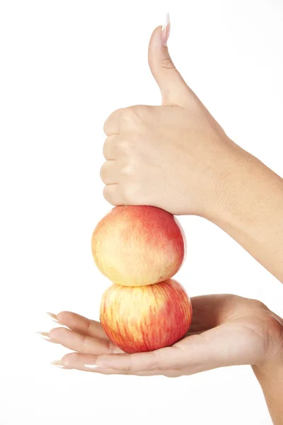 Hand holding two apples and showing hand ok sign — Stock Photo, Image