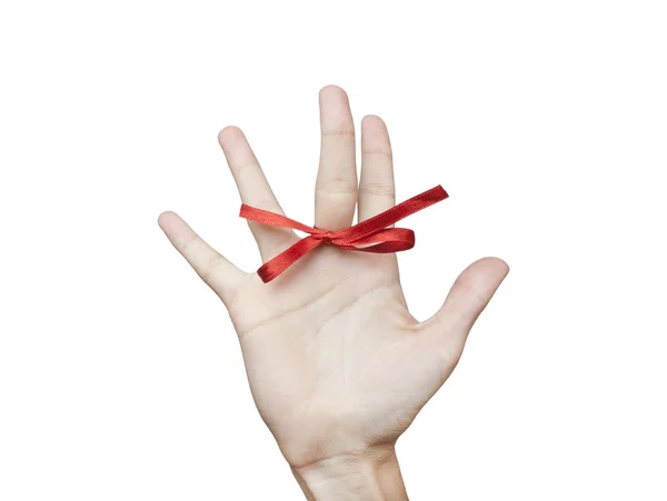 Red bow on a finger — Stock Photo, Image