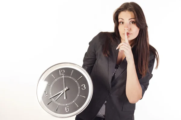 Woman holding clock saying shh — Stock Photo, Image