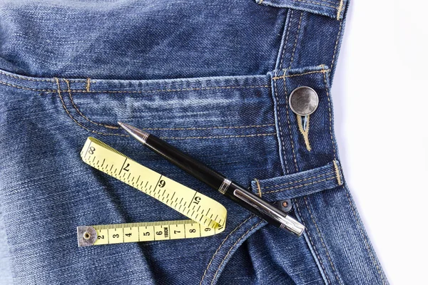 Measuring tape on front blue jeans — Stock Photo, Image