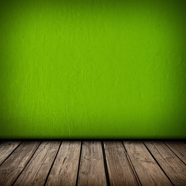 Parede verde e piso interior de madeira — Fotografia de Stock