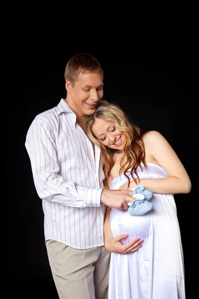 Young couple wait for baby with baby's bootee — Stock Photo, Image