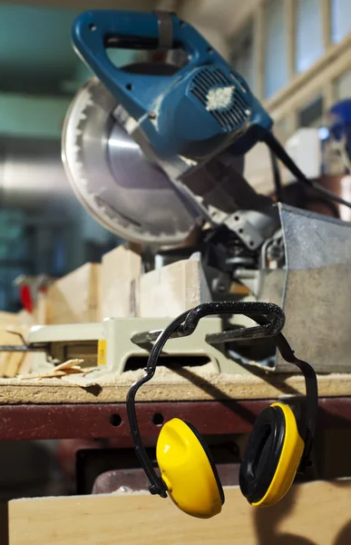 stock image Plywood circular saw and protective earphones