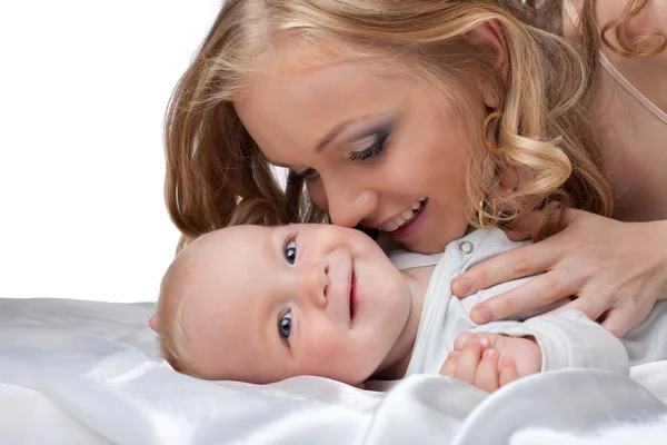 Beauty blond woman kiss a baby — Stock Photo, Image