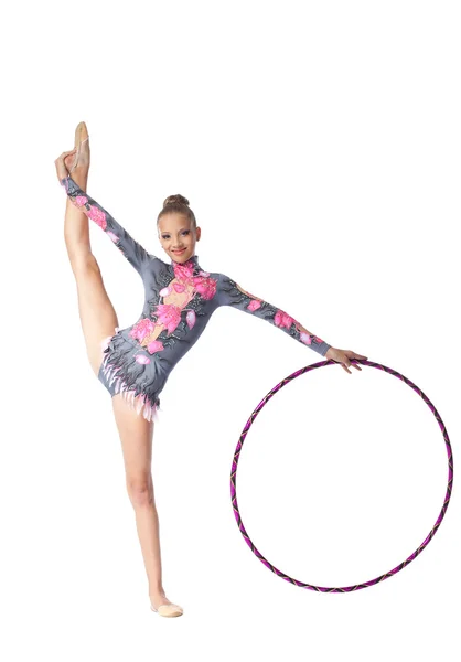 Young gymnast stand on split with hoop — Stock Photo, Image