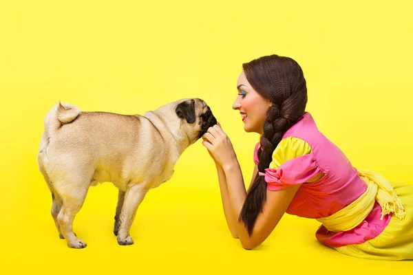 Happy girl like cute doll feed a small dog — Stock Photo, Image