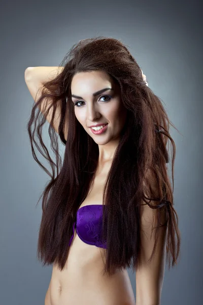 Sexy woman in purple lingerie with hair — Stok fotoğraf
