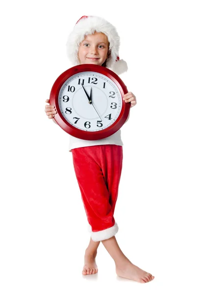 Carino bambina in cappello di Babbo Natale con un orologio — Foto Stock