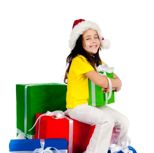 Dívka s dárky v santa hat — Stock fotografie