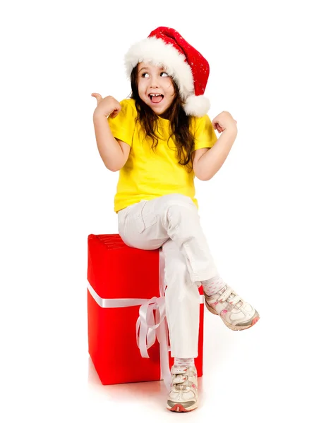 Mädchen mit Geschenken in Weihnachtsmütze — Stockfoto