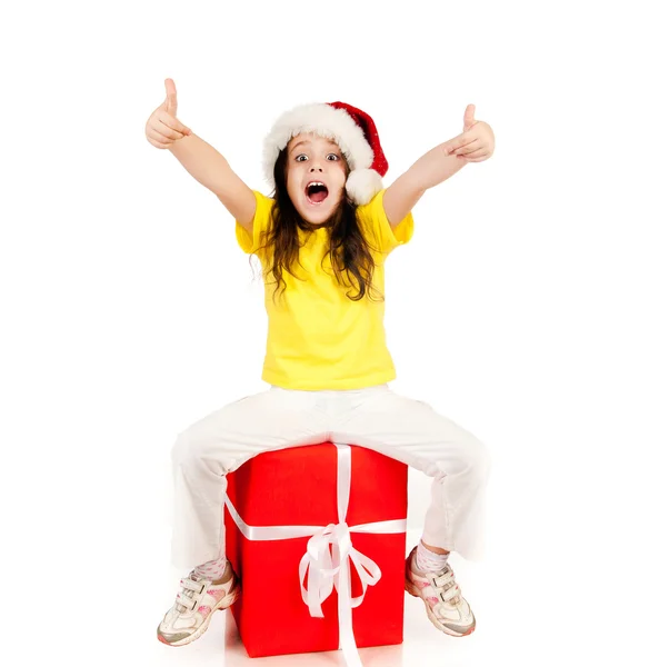 Girl with gifts in santa hat — Stock Photo, Image