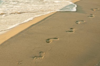 Footprints on the beach clipart