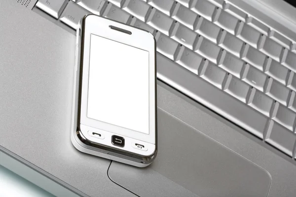 Комунікатор з білим екраном на срібному ноутбуці . — стокове фото