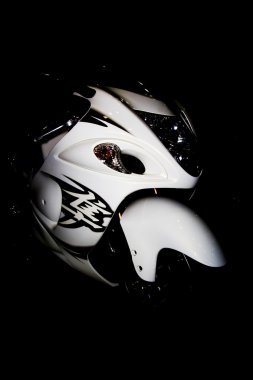 White racing motorcycle on a black background clipart