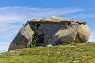 Stone house in the top of a moutain clipart
