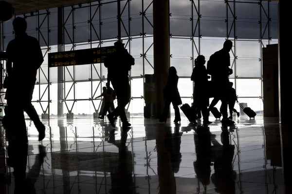 stock image Silhouette of airport travellers