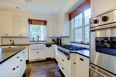 Luxury white kitchen with dark floors. clipart