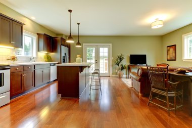 Modern new brown kitchen with cherry floor and living room..