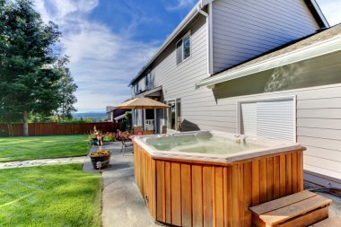 Back yard with house and lrage tub clipart