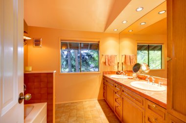 Bathroom with orange yellow tones clipart