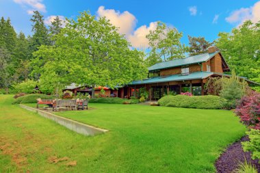 Large cider house with covered deck and garden clipart