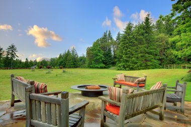 Sitting benches and fire pit and green nature clipart