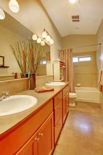 stock image Bathroom with two white sinks and maple cabinets