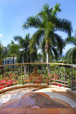 Balcony view from Grand Wailea Resort on the court yard with palm trees. clipart