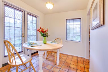 White dining room with french door and orange ceramic tiles clipart