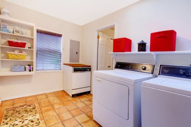 Laundry room with window and ceramic tile floor in a village hou clipart