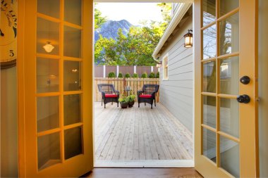 View of the deck from open kitchen french door clipart