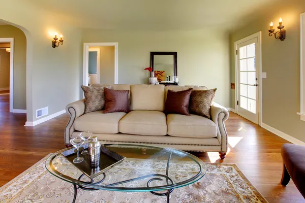 Schönes grünes Wohnzimmer mit Luxus-Sofa und Glas-Cofee-Tisch. — Stockfoto
