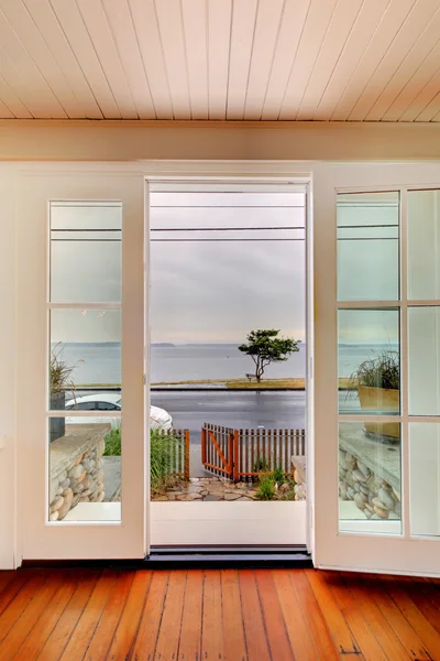 Maison de plage salon avec vue sur l'eau sous la pluie — Photo