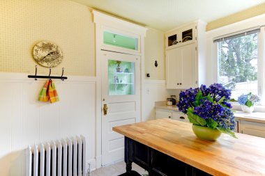 Kitchen with blue flowers and black island. clipart