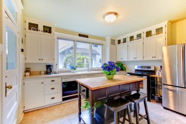 White antique remodeled kitchen with black island. clipart