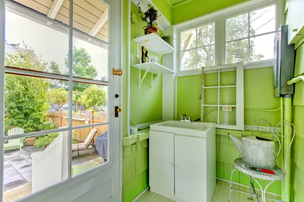 Charming green garden mud room with glass door. — Stock Photo, Image