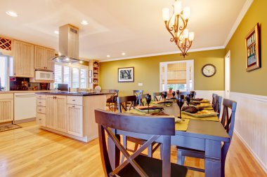 Luxury large kitchen and living room with green walls.