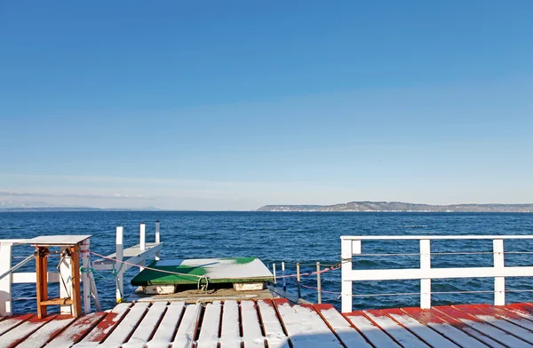 Winter sea dock with snow and water view. — Stock Photo, Image