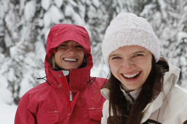 Two young laughing happy women in the snow forest — Stock Photo, Image