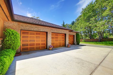 Farm house with large three car garage with nice doors.