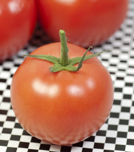 Macro tomatoes on pattern table — Stock Photo, Image