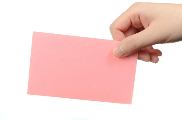 Tarjeta de visita rosa vacía en la mano de una mujer — Foto de Stock