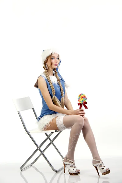 Pretty snow maiden sitting on a white chair — Stock Photo, Image