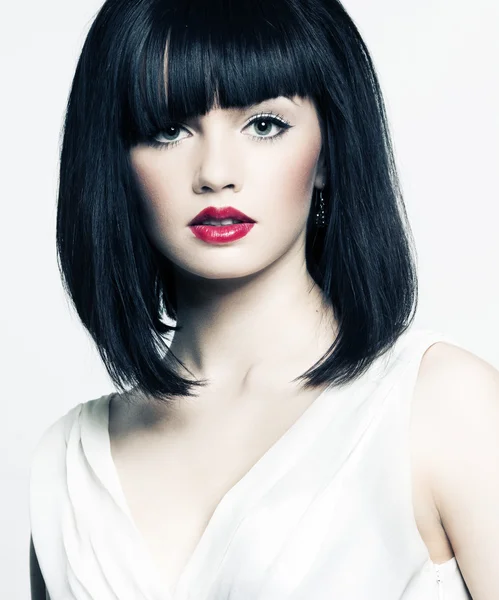 Beautiful girl with perfect skin, red lipstick and black hair on white back — Stock Photo, Image