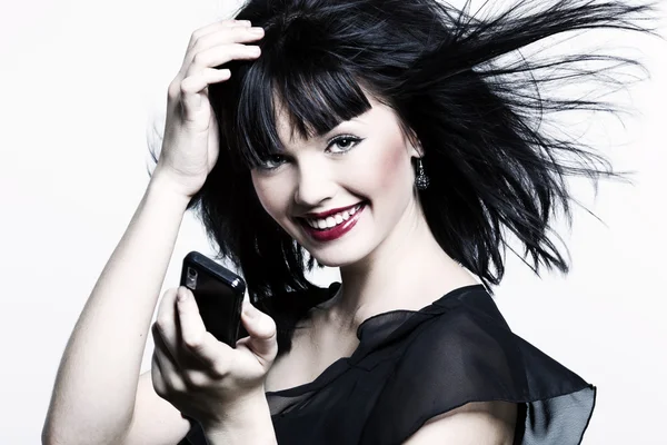 Beautiful girl with perfect skin, red lipstick and black hair with telephon — Stock Photo, Image
