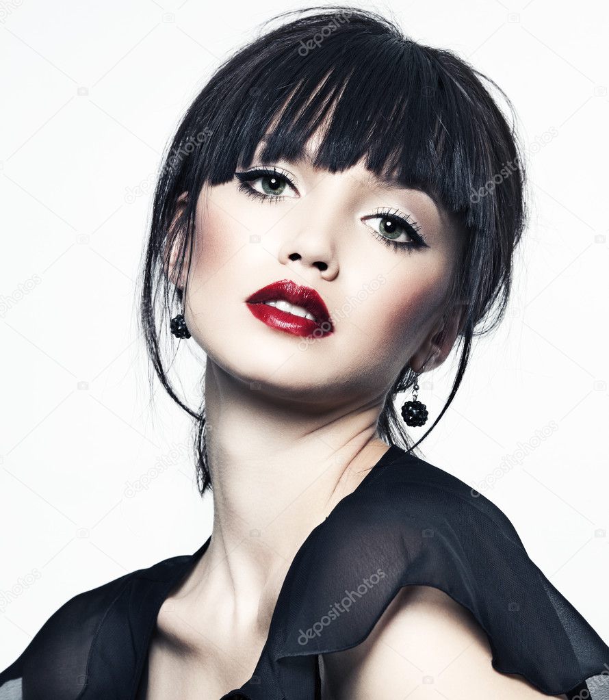 Beautiful girl with perfect skin, red lipstick and black hair on white back