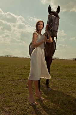 Beautiful girl in a white gown with horse on nature clipart